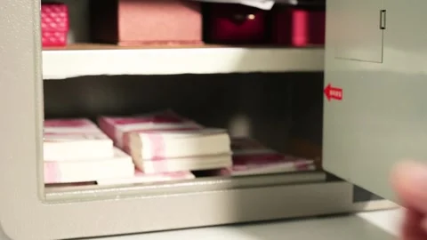 A man opens a safe and takes out Chinese cash 스톡 동영상 277934405