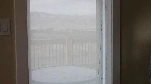 A man opens the shades in the window Stock Footage 56572875