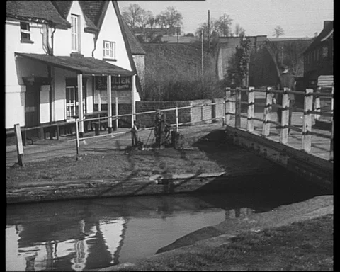 Man opens up swing bridge at Winkwell and boats pass through, UK 1950 Stock Footage 132330111