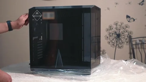 Man opens tempered glass side panel of computer case during assembly Stock Footage 324591921