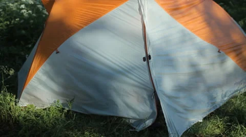 The man opens the tent, making some touch on the smartwatch and close the tent Stock Footage 64311970