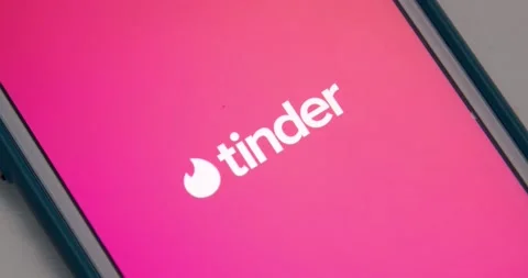 Man opens Tinder app from App Store with fancy animation on iPhone Stock Footage 149426246