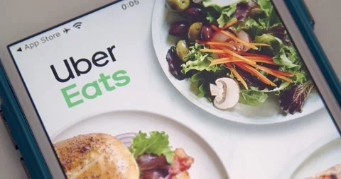 Man opens Uber Eats app from App Store on iPhone Stock Footage 149426737