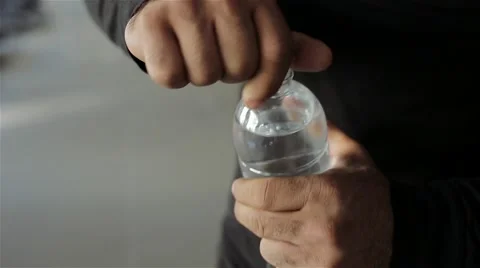 The man opens the water in the gym Stock Footage 56636621