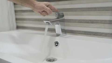 Man opens water tap and washes his hands, selective focus 스톡 동영상 271069212