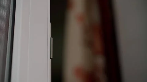 The man opens the white door and enters, closing it behind him. Opening a Stock Footage 234877538