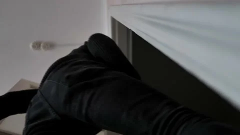 The man opens the white doors and leaves the office or room. Bottom view. Stock Footage 229883151