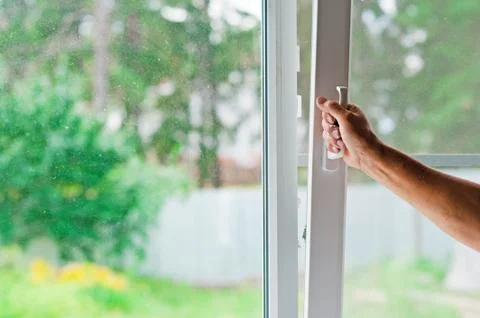 Man opens a window Stock Photos