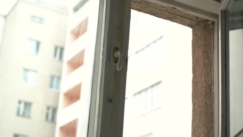A man opens the window window of an apartment Stock Footage 166644696