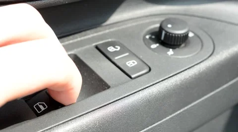 Man opens windows in modern car - detail of control buttons panel Stock Footage 61515666