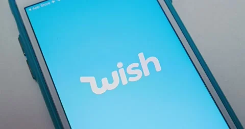 Man opens Wish app with app animation from App Store on iPhone Stock Footage 155988271