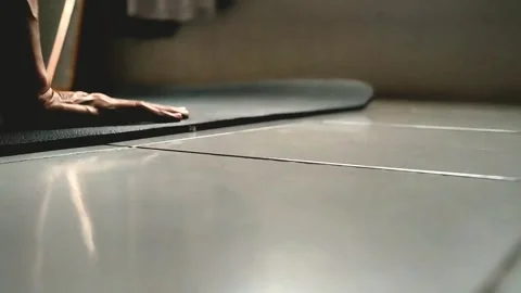 A man opens a yoga mat for exercise in his room Stock Footage 289696150