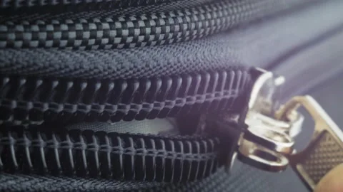 The man opens the zipper of the suitcase. Macro video of a lightning dog. Close Video stock 220226609