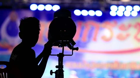 Man operate spot light in night party. Stock Footage 44333273