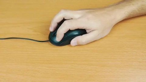 The man operates a computer mouse. Stock Footage 70596382