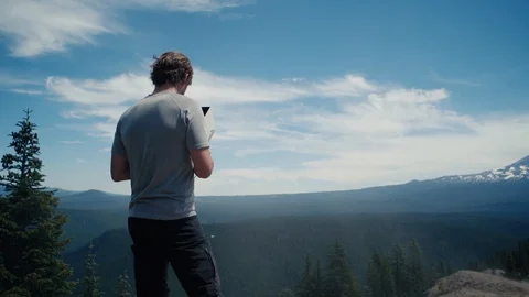 Man operates drone on a mountain ridge Stock Footage 93002202