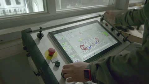 Man operates equipment assembly machine using controller Stock Footage 258763248