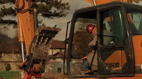 Man operates excavator Stock Footage 21563180