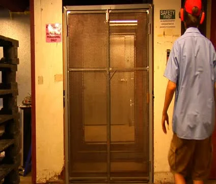 Man operates industrial elevator Stock Footage 21589335