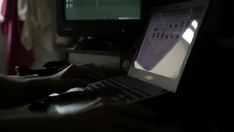 A man operates an old notebook under dark conditions Stock Footage 160359291