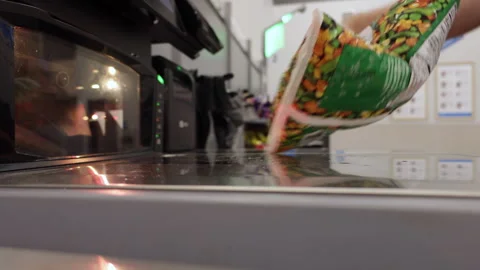 Man operates Self-service Checkout, Scanning His Items and Placing Them in .. Stock Footage 316834267