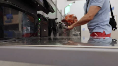 Man operates Self-service Checkout, Scanning His Items and Placing Them in .. Video stock 336861497