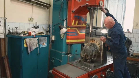 Man operating boring machine - boring of bearing seats on a KAMAZ box. Stock Footage 81543899