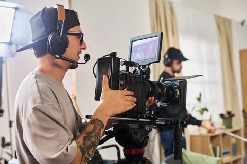 Man Operating Cinema Camera during Video Production in Studio Stock Photos