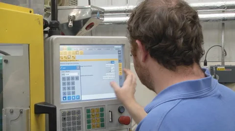 Man operating CNC controls on machinery Stock Footage 46632462