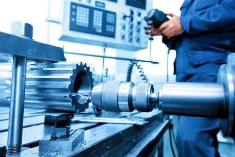 Man operating CNC drilling and boring machine. Industry Stock Photos