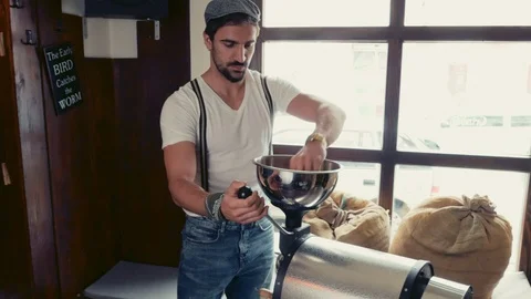 Man operating a coffee beans roasting machine Stock Footage 95911146
