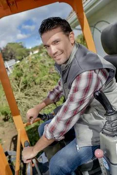 A man operating a digger Stock Photos