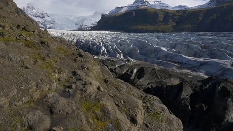 Man operating drone over snow covered mountains Stock Footage 74906469
