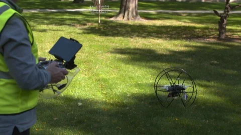Man operating drone in the park Stock Footage 93526699