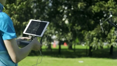 Man Operating a Drone With Remote Control Stock Footage 92351695