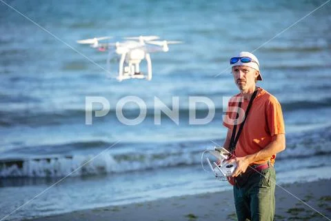 Man operating drone with remote control Stock Photos