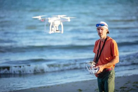 Man operating drone with remote control Stock Photos