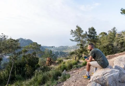 Man operating the drone by remote control and having fun Stock Photos
