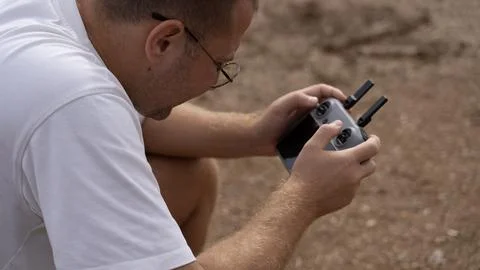 Man Operating Drone Remote Controller Outdoors in Close Up Stock Photos