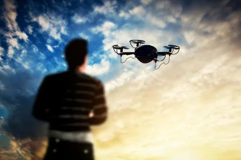 Man operating a drone at sunset. Stock-Fotos