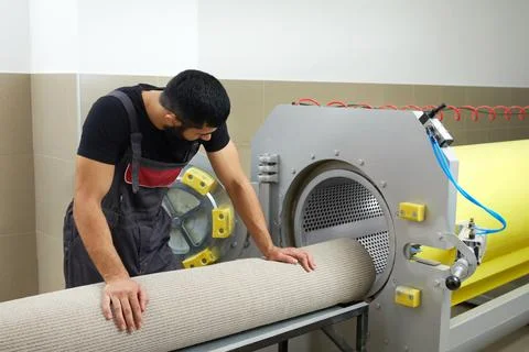 Man operating drying machine for carpet cleaning. Professional carpet cleaning Stock Photos