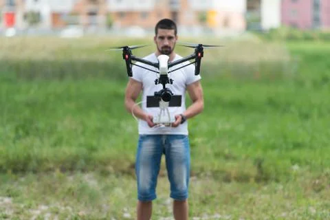 Man Operating a Flying Drone in the Sky Stock Photos
