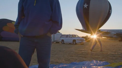 Man operating inflated hot air balloon Stock Footage 87804432