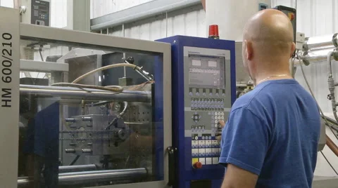 Man operating injection moulding machine Stock Footage 46630823