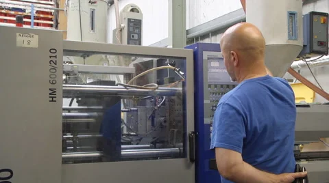 Man operating injection moulding machine Stock Footage 46630891