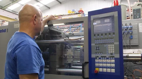 Man operating injection moulding machine Stock Footage 46630994