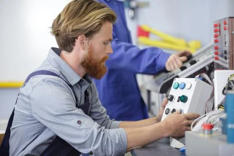 A man is operating machine Stock Photos