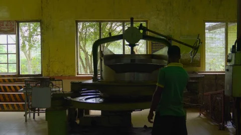Man operating Machine for rolling tea leaves Stock Footage 107213091
