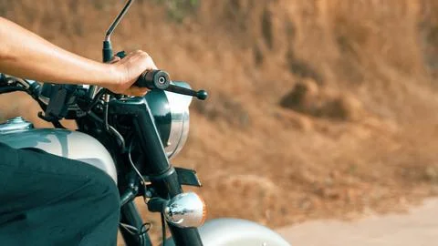 Man operating a motorcycle while riding side view Stock Photos