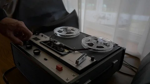 Man operating an old tape recorder Stock Footage 107322385